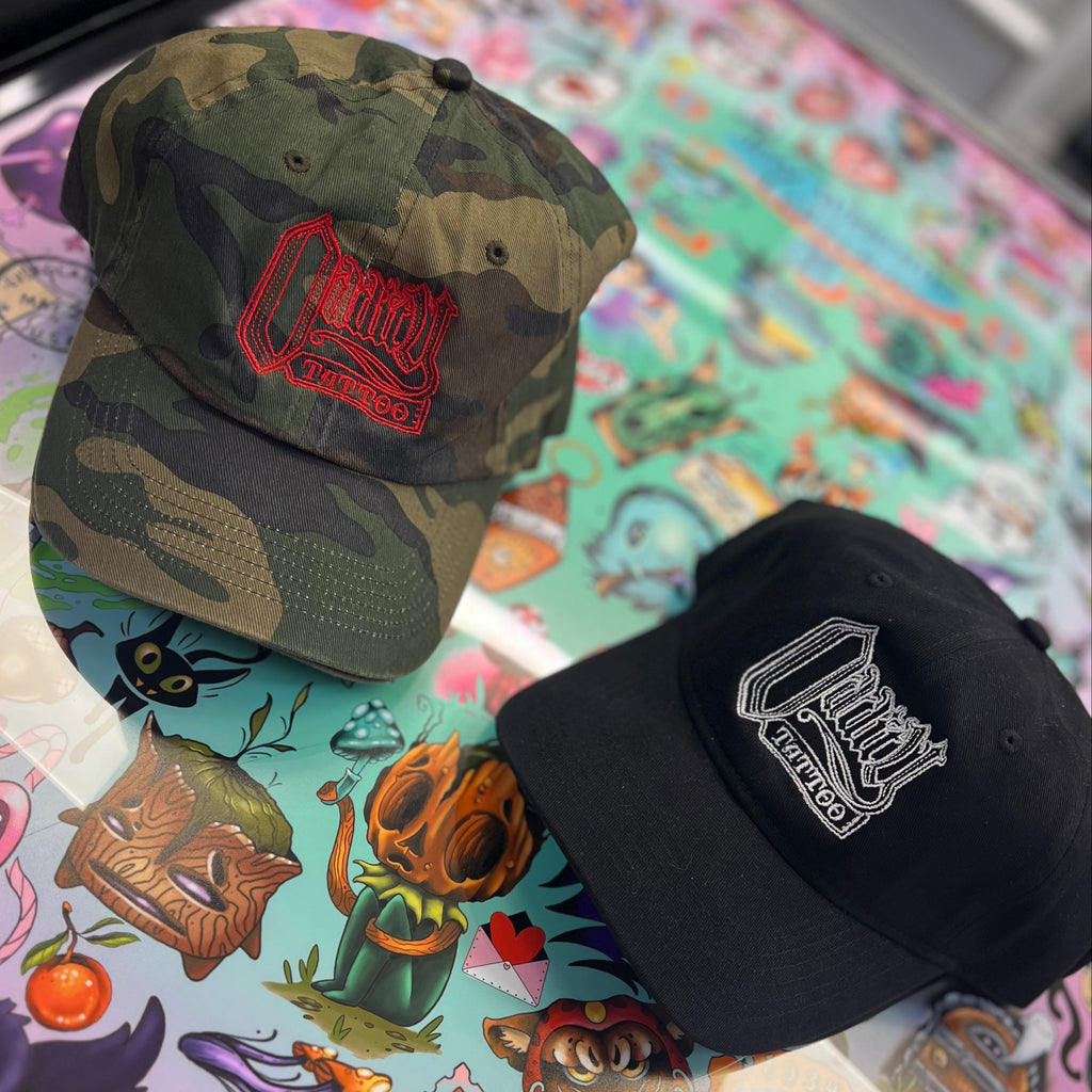 Two baseball caps on a colorful tattoo-style background